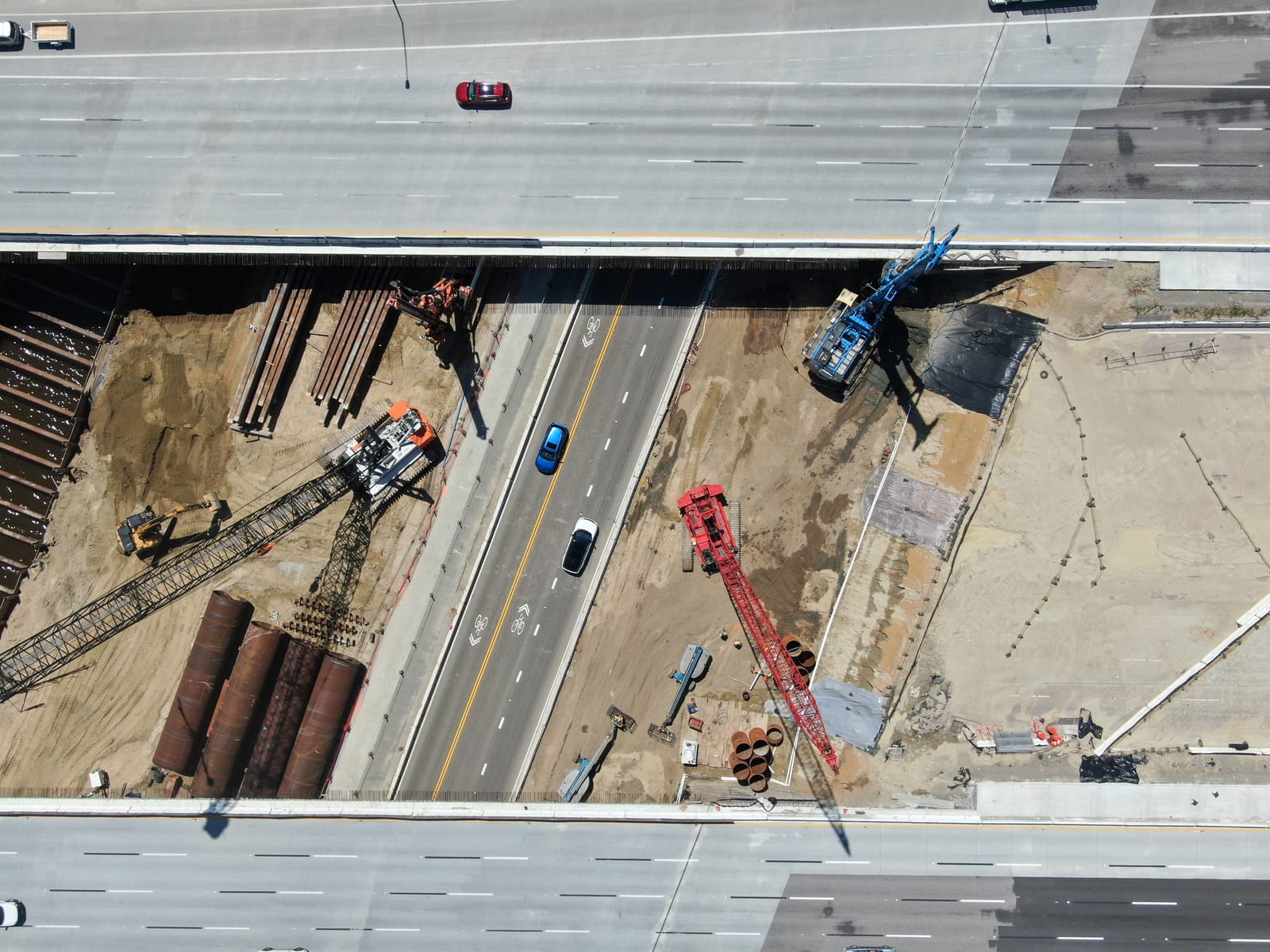 Aerial view of highway bridge construction over a small river